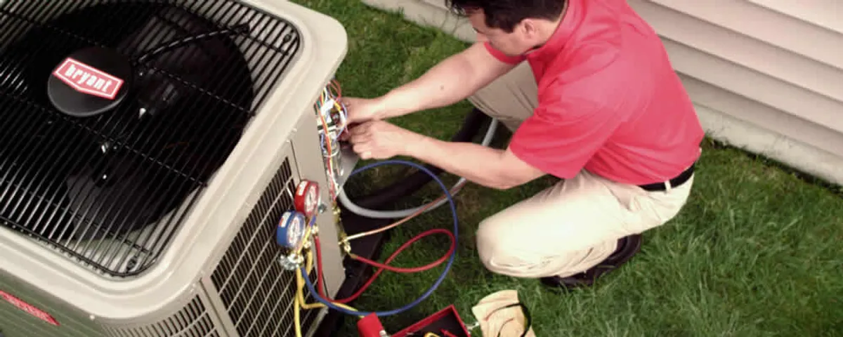 HVAC technician servicing an outdoor air conditioner unit in Hoboken, NJ